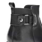 Bota corta de diseño urbano confeccionada en símil cuero liso, con punta redondeada y taco medio recto. Presenta un detalle lateral con tira, hebilla metálica y apliques decorativos, además de una tira trasera para facilitar el calce y cierre interno.