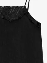 Vestido largo celeste de lino, de silueta recta y finos breteles regulables, con detalles de encaje aplicado en el escote y en el ruedo asimétrico.