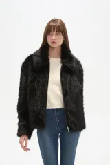 Campera de piel sintética color negro, con cuello, manga larga y cierre frontal. Presenta un diseño de corte holgado y textura suave.