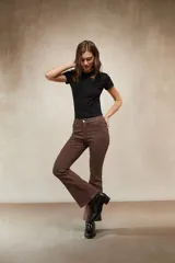 Jean de corte oxford en color negro, con tiro medio y ajuste en la cintura y caderas, ensanchándose desde la rodilla hacia el ruedo.