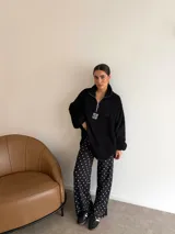 Pantalón de corte recto y holgado, confeccionado en lanilla color marrón oscuro con estampado de lunares blancos. Presenta cintura elástica para mayor comodidad.