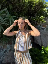 Gargantilla de tiento color beige con dije de caracol de resina.