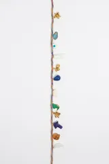 Collar de cordón multicolor con dijes colgantes de resina, latón y esmalte con motivos de animales, símbolos y objetos.