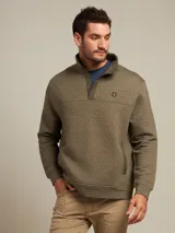 Sweater verde oliva con cuello alto abotonado, corte clásico y diseño acolchado con patrón de rombos.