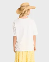 Remera Billabong color beige de corte oversize, manga corta y cuello redondo. Cuenta con estampa frontal con la inscripción "Surf le Soleil" en tonos oscuros y logo de la marca.