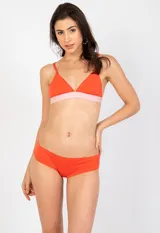 Top de bikini color naranja con escote triangular y banda inferior en color rosado claro. Posee tirantes finos ajustables.