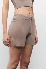 Short tejido negro de viscosa y poliamida, con cintura elástica y tajo en los laterales.