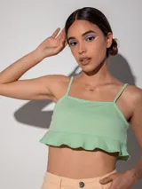 Top blanco de bretel fino con volado en la terminación inferior y textura.