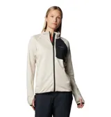 Campera técnica de mujer con cierre frontal completo, confeccionada en tejido transpirable de secado rápido. Presenta cuello alto, bolsillo con cierre en el pecho en contraste de color, y puños con orificios para los pulgares. El diseño incluye ribetes elásticos en puños y dobladillo para mayor ajuste.