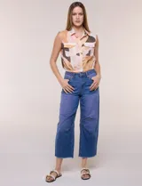 Jean wide leg cropped de tiro medio-alto, confeccionado en denim azul intermedio con efecto degradé y costuras en tono camel. Presenta cinco bolsillos, cierre frontal con botón y cierre, nervaduras decorativas en la zona de las rodillas y ruedo desflecado.