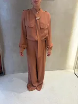 Pantalón de vestir color terracota, de corte recto y tiro alto, con diseño fluido y elegante.