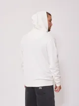 Canguro con cierre y capucha de color blanco, confeccionado con mezcla de algodón y poliéster, con bolsillos tipo canguro y pequeño logo estampado en el pecho.
