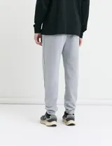 Pantalón jogging de tejido circular con cintura elástica y cordón ajustable. Presenta puños elastizados en el ruedo y bolsillos laterales.