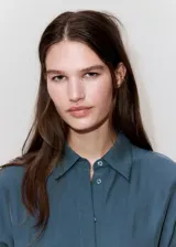 Vestido midi de corte recto color azul, con cuello camisero, mangas cortas y cierre delantero con botones ocultos. Incluye un cinturón ajustable del mismo tejido para anudar en la cintura.