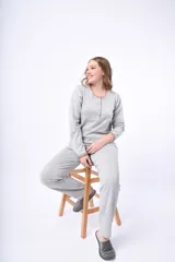 Pijama de dos piezas color coral, de lanilla, compuesto por una camisa de manga larga con botones y un pantalón largo.