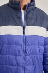 Campera puffer color azul, con diseño colorblock en azul marino y blanco.
