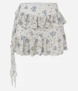 Pollera corta evasé de encaje floral Liberty, con volados asimétricos en capas y forro interno.