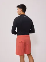 Short de baño color verde menta con cordón de ajuste en la cintura y una franja lateral con diseño de rayas en negro y blanco.