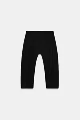 Pantalón capri negro de tiro medio y cintura elástica, confeccionado en hilatura con poliamida.