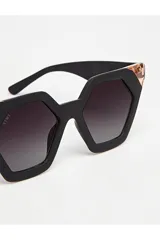 Lentes de sol Tiwi modelo Hexagon II, con montura geométrica negra y detalles en color cobre. Lentes color borgoña con filtro degradado.