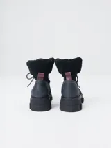 Borcegos de caña baja con diseño robusto, confeccionados en una combinación de gamuza y cuero sintético en tonos verde oliva. Presentan suela track de goma dentada en color suela, cordones al tono con ojalillos amarillos y cuello acolchado para mayor confort.