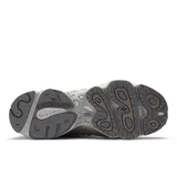 Championes New Balance modelo 1000 color plateado y beige, con detalles en negro. Diseño futurista con superposiciones de malla y ante, amortiguación ABZORB en talón y antepié, y caña Stability Web en el mediopié.