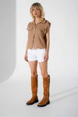 Bucanera color camel con suela negra tipo track, caña alta y cierre lateral.