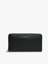 Billetera larga Tommy Hilfiger de diseño plano y textura granulada, con cierre perimetral y logo metalizado en el frente.