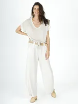 Pantalón de lino color crudo, de corte palazzo, con cintura alta y lazo de ajuste.