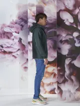 Campera verde oscuro con capucha, cierre frontal y bolsillos laterales.