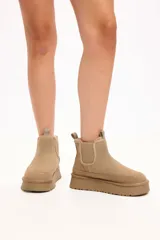 Bota tipo chelsea de gamuza color camel, con interior forrado en piel sintética, elásticos laterales y plataforma alta con suela dentada.