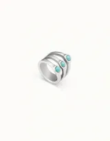 Anillo plateado con tres bandas y tres cristales de murano color turquesa.
