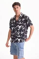 Camisa de viscosa de manga corta con corte clásico, de color negro con estampado abstracto en contraste.