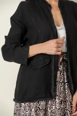 Blazer celeste de lino con corte recto, cuello mao y aplique desflecado en cuello y ruedo.