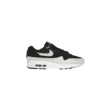 Championes Nike Air Max 1 Essential, color negro y gris claro con el swoosh en blanco. Cuentan con unidad Max Air visible en el talón.