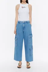 Pantalón cargo de denim celeste, corte ancho, tiro medio, con bolsillos laterales con solapa y cierre de botón y bolsillos delanteros y traseros.
