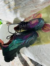 Zapatillas marrones con cordones y suela de goma negra.