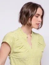 Top celeste de manga corta con cuello mao y tablas. Confeccionado en tela con textura.