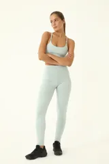 Top deportivo celeste de compresión media, con elástico invisible y tiras delgadas.