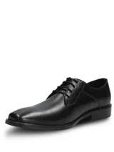 Zapato de vestir formal Hush Puppies modelo Blues, confeccionado en cuero negro con cierre de cordones. Presenta una silueta clásica con puntera redondeada y suela de goma resistente.