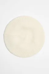 Boina color crudo de punto acanalado con etiqueta de silicona con logo.