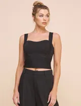 Top crop negro de corte ajustado y estructurado, con escote corazón, tirantes anchos y textura acanalada fina con costuras estilo corsé.