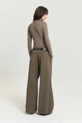Pantalón pinzado color marrón de corte sastrero, confeccionado en tencel con elastano. Presenta pinzas en el delantero, bolsillos delanteros americanos y bolsillos ojal traseros.