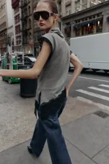 Top sin mangas con cuello subido, confeccionado en tejido con estampado pata de gallo. Presenta un diseño asimétrico en el bajo decorado con encaje negro, detalle que también se encuentra en las sisas.