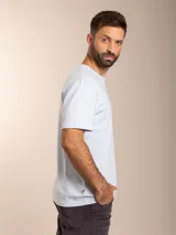 Remera básica de manga corta y cuello redondo, color blanco, con pequeño logo bordado en el pecho.