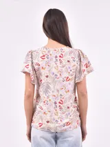 Blusa estampada con cuello en V y lazo ajustable en el escote. Presenta mangas cortas con ligero volumen y un corte holgado con frunces bajo el busto.