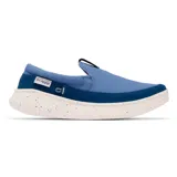 Zapatilla tipo slip-on Columbia Boatside PFG, color azul, con empeine de lona y ante. Presenta una suela de plataforma blanca con motas de colores y tecnología Omni-GRIP LT para mayor tracción y ligereza.