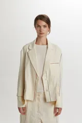 Chaquetas de algodón y lino color beige, con diseño de rayas finas y cierre frontal de botones.