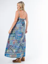 Vestido largo de algodón con estampado multicolor, corte cuadrado y elástico en la espalda. Incluye un aplique de flor desmontable.