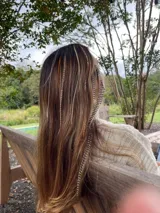 Mix de plumas para cabello, incluyendo plumas largas con patrón moteado/rayado en tonos marrones y grises, y plumas finas lisas en tonos blanco y naranja.